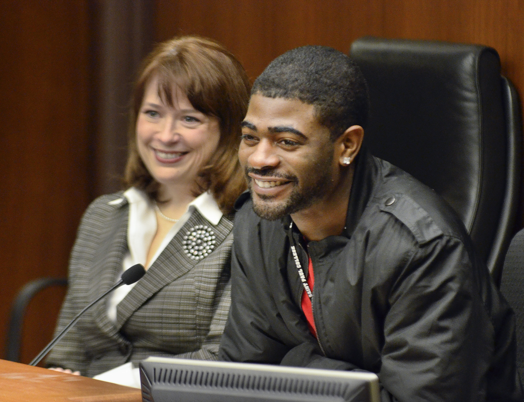 Jeremiah Carter testifies before the House Health and Human Services Finance Committee March 20 in support of a bill sponsored by Rep. Laurie Halverson, left, that would provide funding for Homeless Youth Act activities. Photo by Andrew VonBank